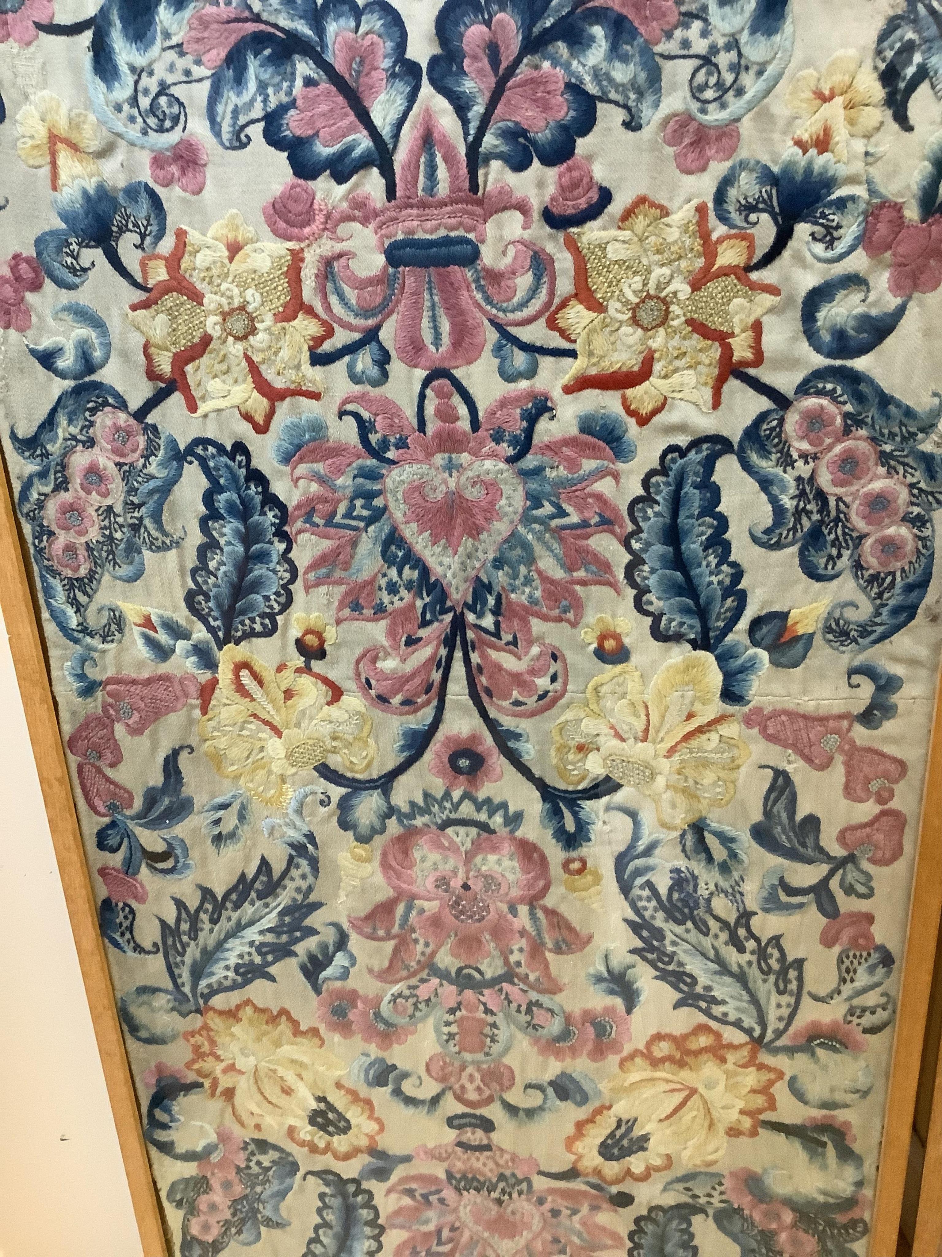 Two unusual 19th- 20th century French crewel worked panels. Embroidered predominantly in shades of blue, pink, yellow and orange, onto a light grey cloth, using neoclassical and rococo design elements. Possibly part of a